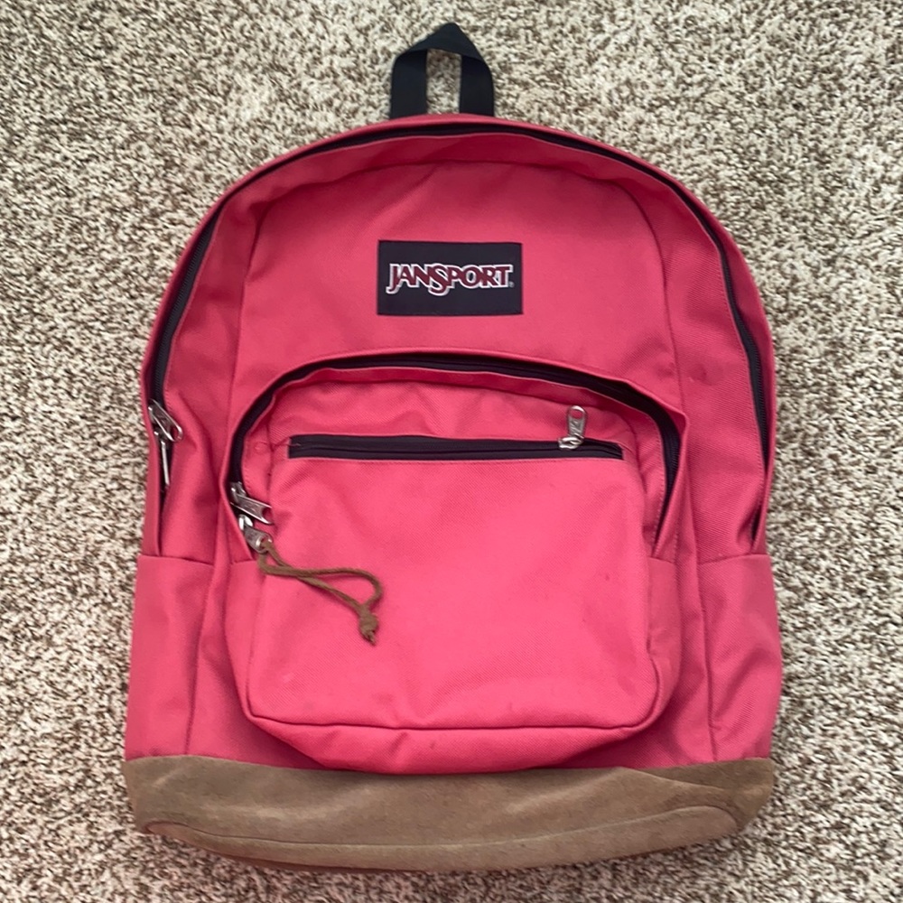 Jansport. Pink backpack with leather bottom.Approx 18”x 15”. Padded laptop pkt